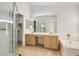 Bright bathroom with dual sinks, soaking tub, and separate shower with glass doors at 3912 Branchwood Dr, North Las Vegas, NV 89032