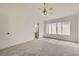 Bright bedroom with carpet, large window, ceiling fan, and neutral paint at 3912 Branchwood Dr, North Las Vegas, NV 89032