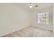 Bright bedroom features plush carpet, a ceiling fan, and a window providing natural light at 3912 Branchwood Dr, North Las Vegas, NV 89032