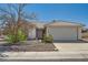 Single-story home featuring desert landscaping, a tile roof, and an attached two-car garage at 3912 Branchwood Dr, North Las Vegas, NV 89032