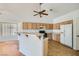Open-concept kitchen featuring light cabinets, tile floors and eat-in bar at 3912 Branchwood Dr, North Las Vegas, NV 89032