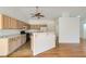 Spacious kitchen featuring light cabinets, tile floors, and an eat-in breakfast bar at 3912 Branchwood Dr, North Las Vegas, NV 89032