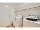 Practical laundry room with washer, dryer, and built-in shelving for storage at 3912 Branchwood Dr, North Las Vegas, NV 89032