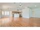 Open-concept living area with wood floors, ample natural light, and seamless flow to the kitchen at 3912 Branchwood Dr, North Las Vegas, NV 89032
