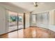 Bright living room with wood floors, vaulted ceiling, and sliding glass door to the backyard at 3912 Branchwood Dr, North Las Vegas, NV 89032