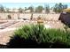 View of the landscaped backyard featuring a brick border and gravel at 3954 Saddlewood Ct, Las Vegas, NV 89121