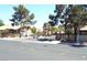 A gated community entrance featuring dual gates, mature landscaping, and well-maintained street at 3954 Saddlewood Ct, Las Vegas, NV 89121