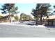 View of the gated community entrance with dual gates and mature landscaping at 3954 Saddlewood Ct, Las Vegas, NV 89121