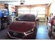 View of the garage with car parked inside, and storage shelves at 3954 Saddlewood Ct, Las Vegas, NV 89121