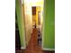 Hallway leading to a bathroom with hardwood floors and bright walls at 3954 Saddlewood Ct, Las Vegas, NV 89121