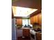 Well-lit kitchen with wood cabinetry, a corner sink, and modern appliances at 3954 Saddlewood Ct, Las Vegas, NV 89121