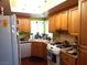 Well-lit kitchen with wood cabinetry, a corner sink, and modern appliances at 3954 Saddlewood Ct, Las Vegas, NV 89121