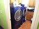 Bright laundry room featuring a full-size washer and dryer set with built in storage at 3954 Saddlewood Ct, Las Vegas, NV 89121