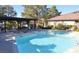 Exterior shot of the community pool and hot tub with lounge chairs and covered seating area nearby at 3954 Saddlewood Ct, Las Vegas, NV 89121