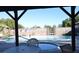 View of the community pool and hot tub area from under the covered patio, looking out to the privacy wall at 3954 Saddlewood Ct, Las Vegas, NV 89121