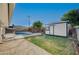 View of the backyard, showing the shed, pool, and fence at 4284 Parkdale Ave, Las Vegas, NV 89121