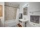 Bathroom featuring shower over bath and a pedestal sink with wooden floors and chrome fixtures at 4284 Parkdale Ave, Las Vegas, NV 89121