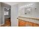 The bathroom has a granite-top vanity with wood cabinets and a well-lit mirror at 4284 Parkdale Ave, Las Vegas, NV 89121