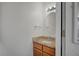 Bathroom includes wood cabinets, marble counter, oval mirror, and vanity lighting at 4284 Parkdale Ave, Las Vegas, NV 89121