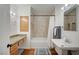 The bathroom has a spacious shower-tub combo, stylish lighting, and well-lit vanity at 4284 Parkdale Ave, Las Vegas, NV 89121