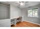 Bright bedroom features a built-in desk, closet, and wood flooring, complemented by neutral paint and a ceiling fan at 4284 Parkdale Ave, Las Vegas, NV 89121