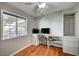 Bedroom features a built in desk, closet, and large window providing natural light and street views at 4284 Parkdale Ave, Las Vegas, NV 89121