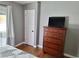 This bedroom features hardwood floors and a dresser with a television on top at 4284 Parkdale Ave, Las Vegas, NV 89121