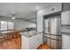 Open kitchen and dining area featuring stainless steel appliances, granite counters and wood flooring at 4284 Parkdale Ave, Las Vegas, NV 89121