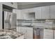 Well-lit kitchen with white cabinets, granite countertops, stainless steel oven and cooktop at 4284 Parkdale Ave, Las Vegas, NV 89121
