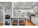 Updated kitchen features granite countertops, stainless steel appliances, white cabinetry, and modern recessed lighting at 4284 Parkdale Ave, Las Vegas, NV 89121