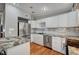Modern kitchen boasts stainless steel refrigerator, granite countertops, and white cabinetry at 4284 Parkdale Ave, Las Vegas, NV 89121