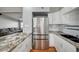 Contemporary kitchen with stainless steel refrigerator, granite countertops, and white cabinets at 4284 Parkdale Ave, Las Vegas, NV 89121