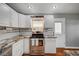 Updated kitchen featuring granite countertops, stainless steel appliances, and white cabinetry at 4284 Parkdale Ave, Las Vegas, NV 89121
