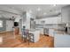 Bright, modern kitchen features an island, granite countertops, stainless steel appliances, and wood flooring at 4284 Parkdale Ave, Las Vegas, NV 89121