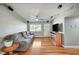 Cozy living room featuring hardwood floors, modern lighting, and front door access at 4284 Parkdale Ave, Las Vegas, NV 89121