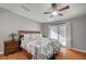 Main bedroom with hardwood floors, ceiling fan, and sliding glass doors to the exterior at 4284 Parkdale Ave, Las Vegas, NV 89121