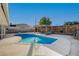 Backyard view of a sparkling pool with a covered patio and privacy fence at 4284 Parkdale Ave, Las Vegas, NV 89121