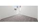 Bright bedroom featuring fresh carpet and natural light from the large window at 4410 E Brusca Way, Pahrump, NV 89061