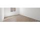 A simple bedroom featuring tile floors, natural light, and a clean, minimalist design at 4410 E Brusca Way, Pahrump, NV 89061