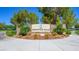 Inviting stone entrance sign for Mountain Falls community with lush landscaping and well-maintained grounds at 4410 E Brusca Way, Pahrump, NV 89061