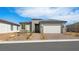 Charming single-story home featuring a 2-car garage, desert landscaping, and a welcoming front entrance at 4410 E Brusca Way, Pahrump, NV 89061