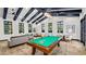 Relax in the game room featuring a pool table, sofa, ceiling fan, and lots of natural light at 4410 E Brusca Way, Pahrump, NV 89061