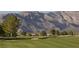 Beautiful golf course with rolling green hills and stunning mountain views in the background at 4410 E Brusca Way, Pahrump, NV 89061