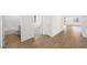 Hallway showing wood-look floors, bathroom, bedroom and transition to other rooms at 4410 E Brusca Way, Pahrump, NV 89061
