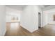Hallway with wood-look tile flooring transitions into bright, open living spaces with natural light at 4410 E Brusca Way, Pahrump, NV 89061