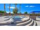 The hot tub is surrounded by a concrete patio with tiered seating and lush landscaping at 4410 E Brusca Way, Pahrump, NV 89061