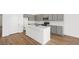 Modern kitchen with white backsplash, grey cabinets, an island, and stainless steel appliances at 4410 E Brusca Way, Pahrump, NV 89061