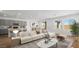 Open-concept living room with sleek furniture, modern kitchen view, and a bright atmosphere at 4410 E Brusca Way, Pahrump, NV 89061