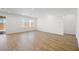 Spacious living room with wood-look tile flooring and large windows for natural light at 4410 E Brusca Way, Pahrump, NV 89061