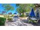 Relaxing outdoor patio area with comfortable seating, serene landscaping, shade trees and tranquil ambiance at 4410 E Brusca Way, Pahrump, NV 89061